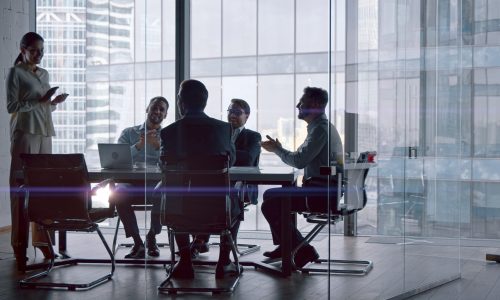 Professionals at work: business team discussing financial strategies in a crisis while sitting at desk